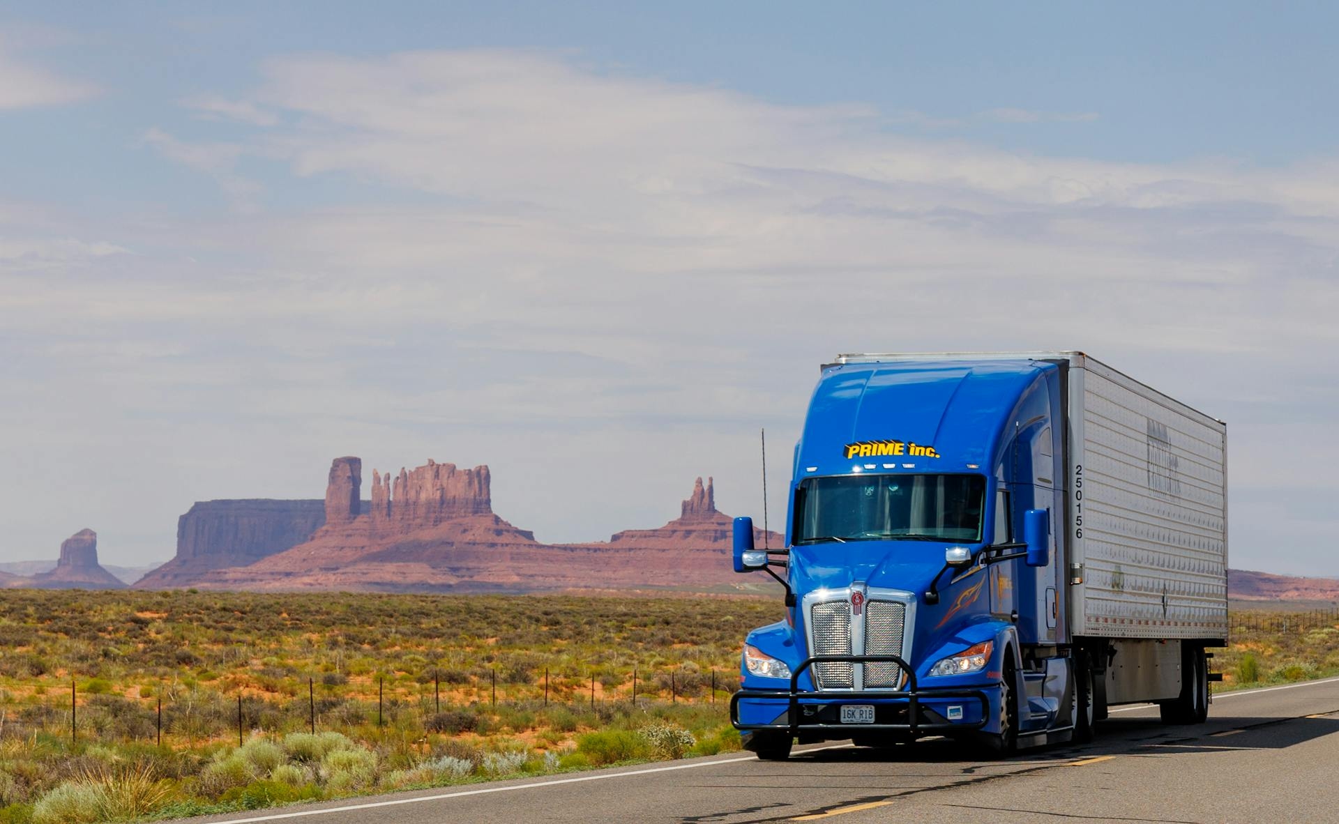 Semi truck crossing a blue-hour desert highway